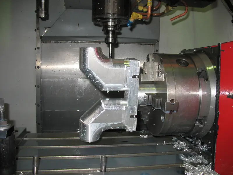 Four-axis CNC milling a complex aluminium component with rotary chuck